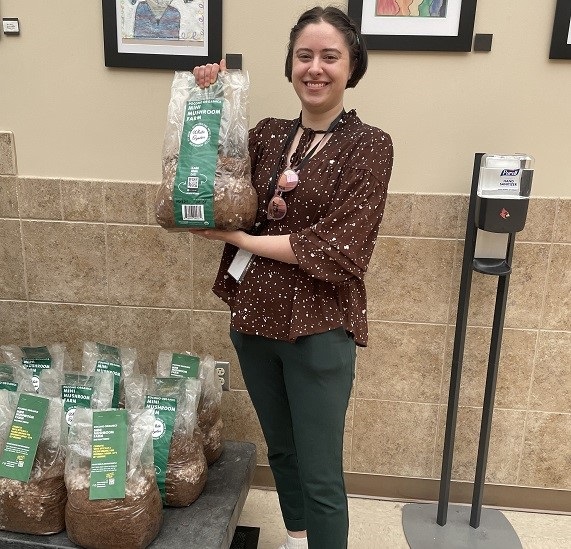 Registered Dietitian Monique Mazaika poses with a Mini Mushroom Farm from Pocono Organics.